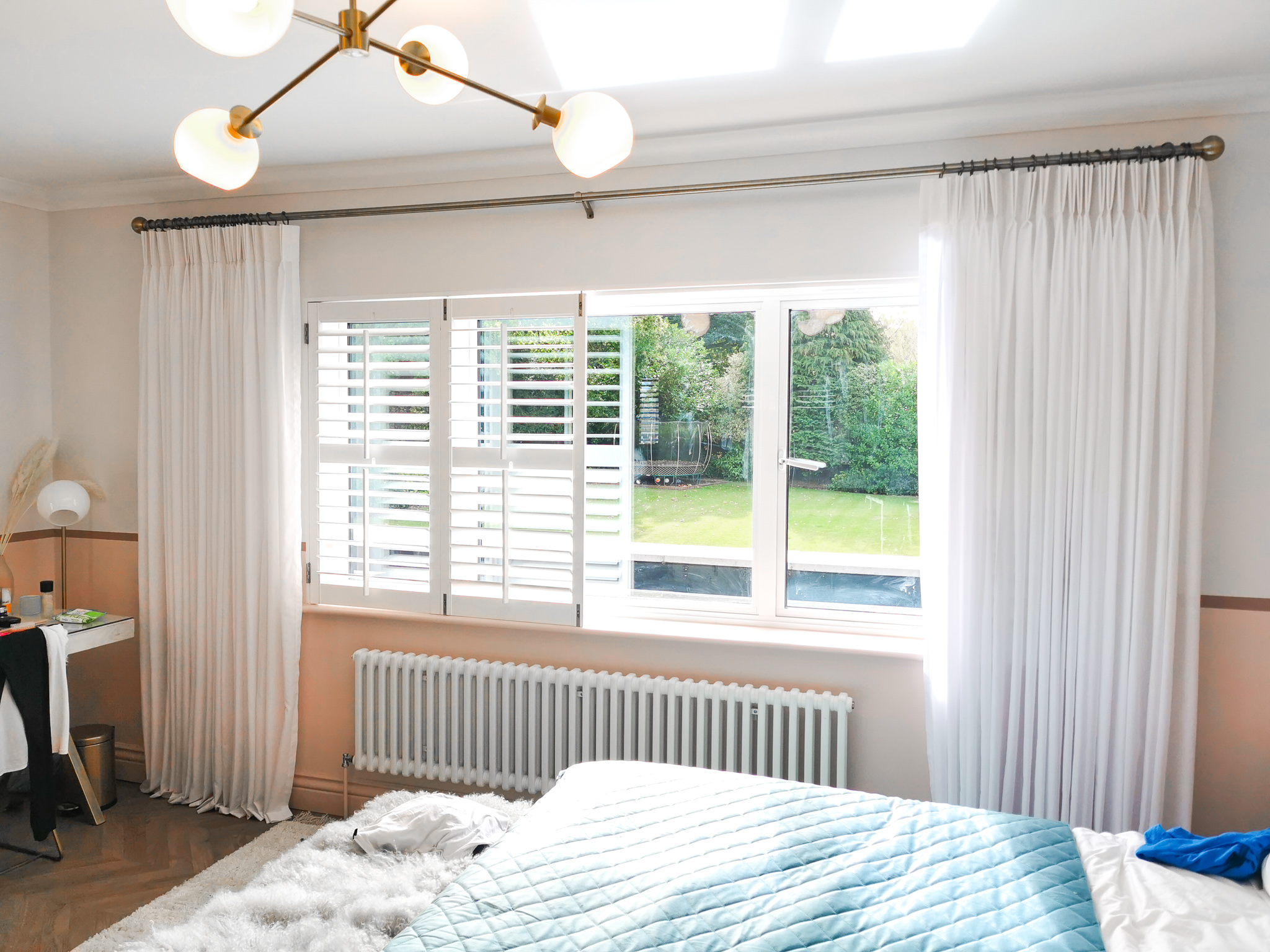 Bedroom sheer curtains with gold pole and shutters