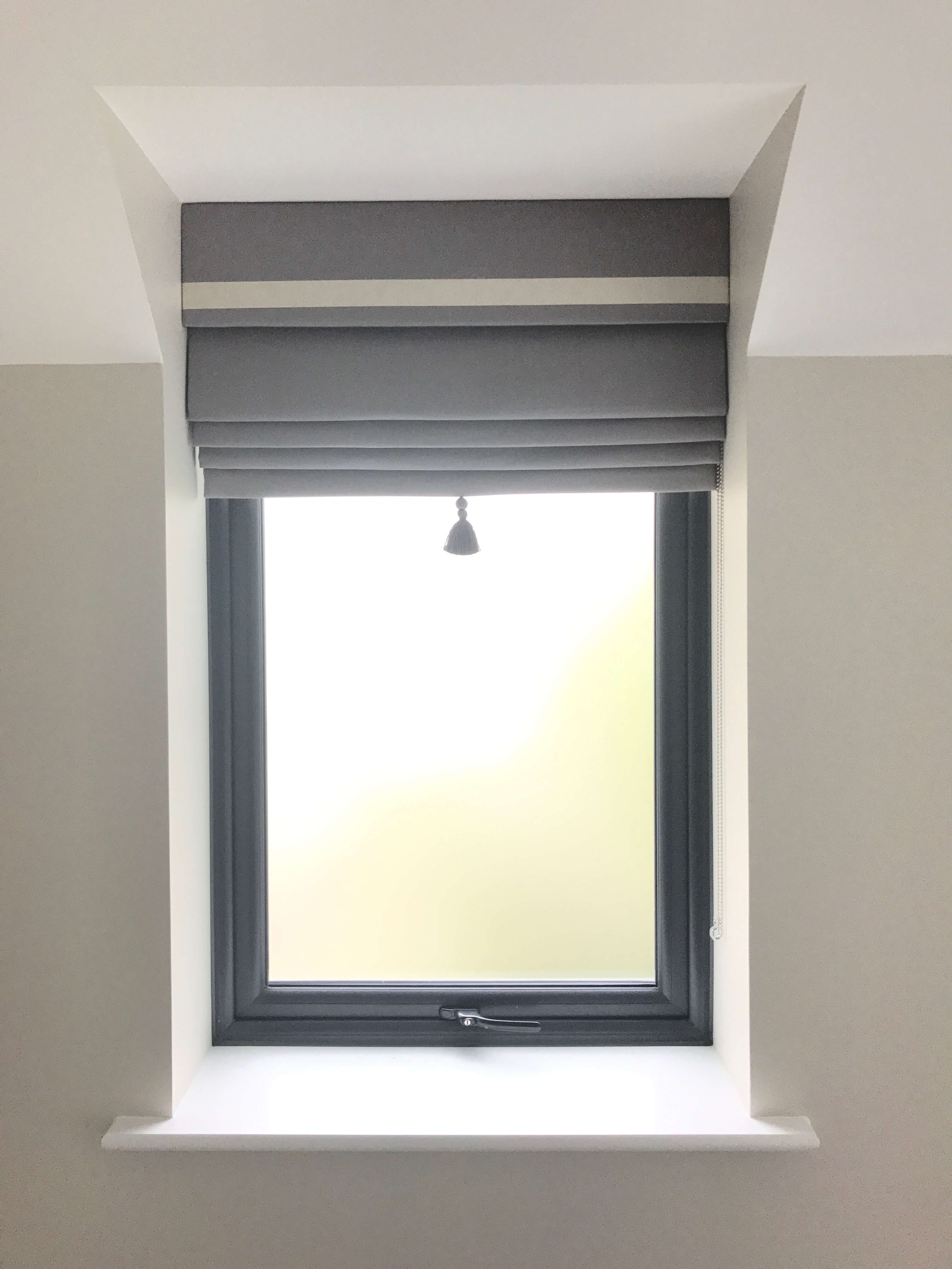Grey roman blind with bordered fascia 