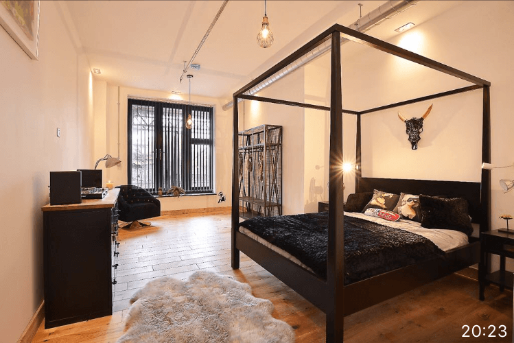 Bedroom with black slatted vertical blinds